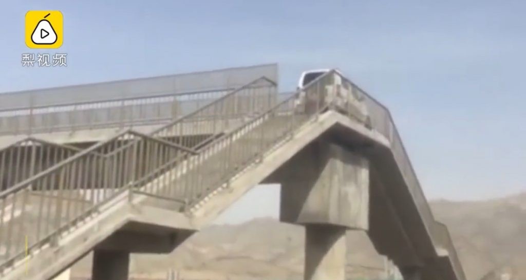Driver misses his exit on Chinese highway – proceeds to drive up a pedestrian bridge